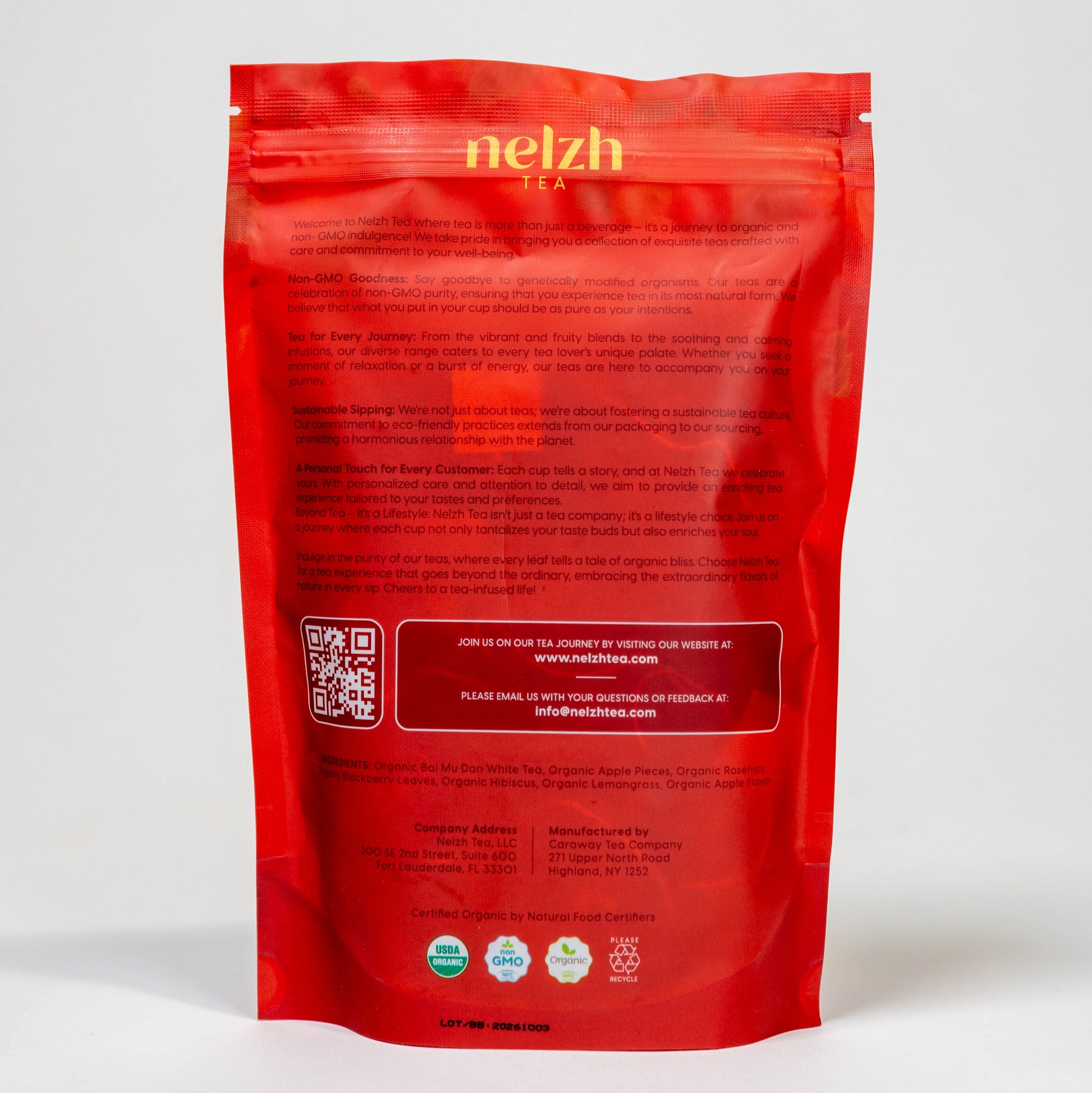 he back of the Nelzh Tea bag, Apple Sensation. The text describes the company's commitment to organic ingredients and sustainability, with a QR code, company address, and a list of ingredients.