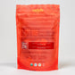 The back of the Nelzh Tea Organic Pomegranate Paradise bag, displaying a list of ingredients including organic hibiscus, organic rosehips, and organic lemongrass.