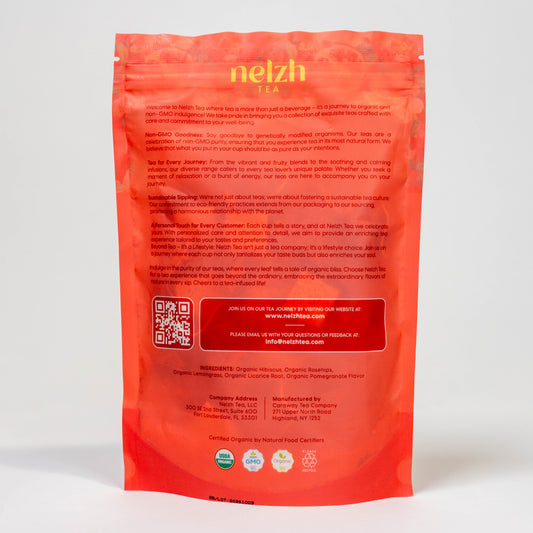 The back of the Nelzh Tea Organic Pomegranate Paradise bag, displaying a list of ingredients including organic hibiscus, organic rosehips, and organic lemongrass.